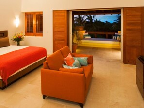 A bedroom with a bed, a sofa, a nightstand, and a view of a balcony with a pool. - Casa Sabba at Las Palmas Punta Mita Bunk Room (Punta de Mita)