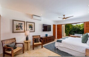 A bedroom with a bed, two chairs, a TV, and a ceiling fan. - 4BR Las Palmas Villa Premier Golf Private Pool Cook 3 Golf Carts - Las Palmas 21 Casa Rayo De Sol (Punta de Mita)