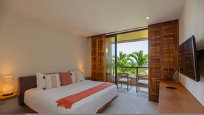 A bedroom with a bed, bedside tables, a TV, and a balcony with chairs. - 3 Bed 3 5 Bath Condo With Hsk Pool Ocean View (Punta de Mita)