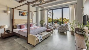 A modern bedroom with a four-poster bed, a balcony with seating, and a TV. - Lavender Villa by BasilStays (Calangute)