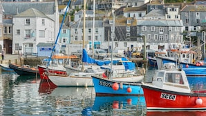 A harbor with boats docked, buildings in the background, and a clear view of the water. - Luxury Coastal Cottage With Harbour Views (St Austell)