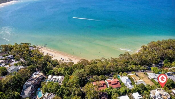 An aerial view of a coastal area with a beach, houses, and a swimming pool. - Two Bedroom Beach Bungalow (Noosa Heads)
