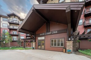 A multi-story building with a sign reading 'BASE CAMP ONE.'