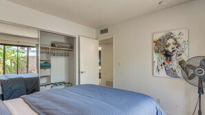 A bedroom with a bed, a closet, a fan, and a painting on the wall. - 1 Mi to Dtwn Palm Springs! Desert Escape w/ Pool (Palm Springs)
