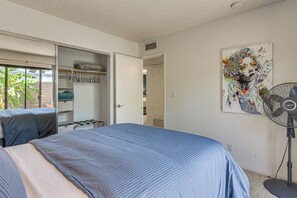 A bedroom with a bed, a closet, a fan, and a painting on the wall. - 1 Mi to Dtwn Palm Springs! Desert Escape w/ Pool (Palm Springs)