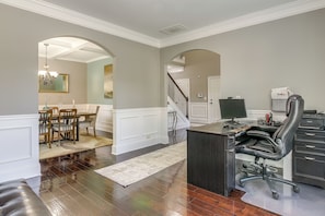 A spacious room with a desk, office chair, and a dining area with chairs and a table. - Spacious Group Hub! Walk to Tribble Mill Park (Lawrenceville)