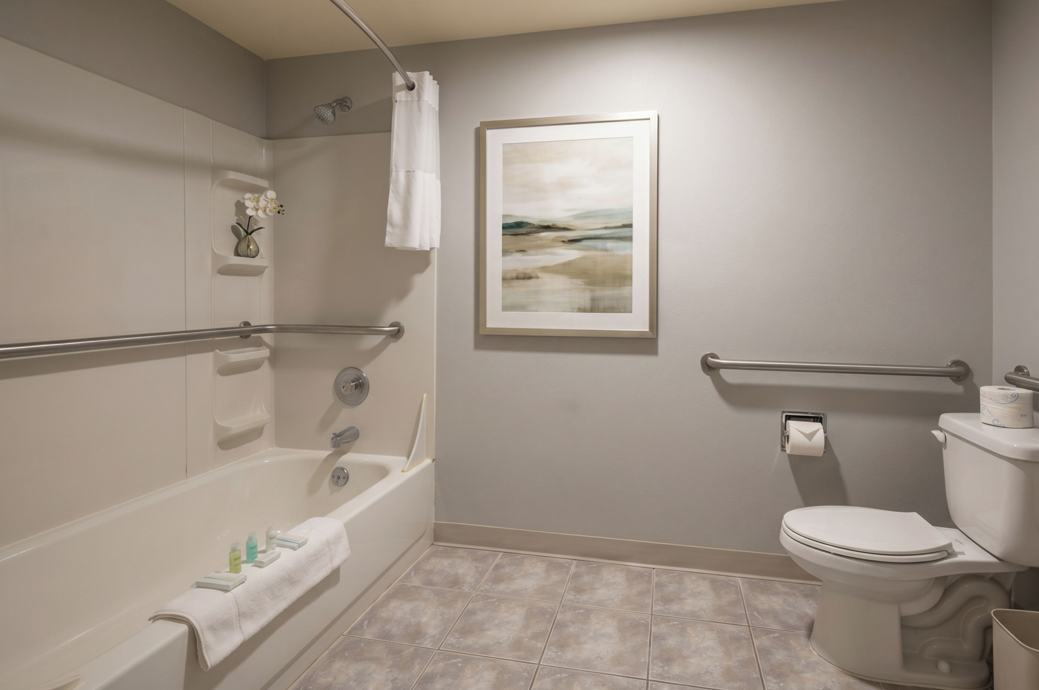 A bathroom with a bathtub, toilet, and a shower area.