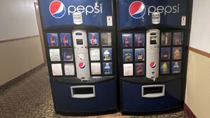 Two Pepsi vending machines with a variety of drink options and a calorie counter.