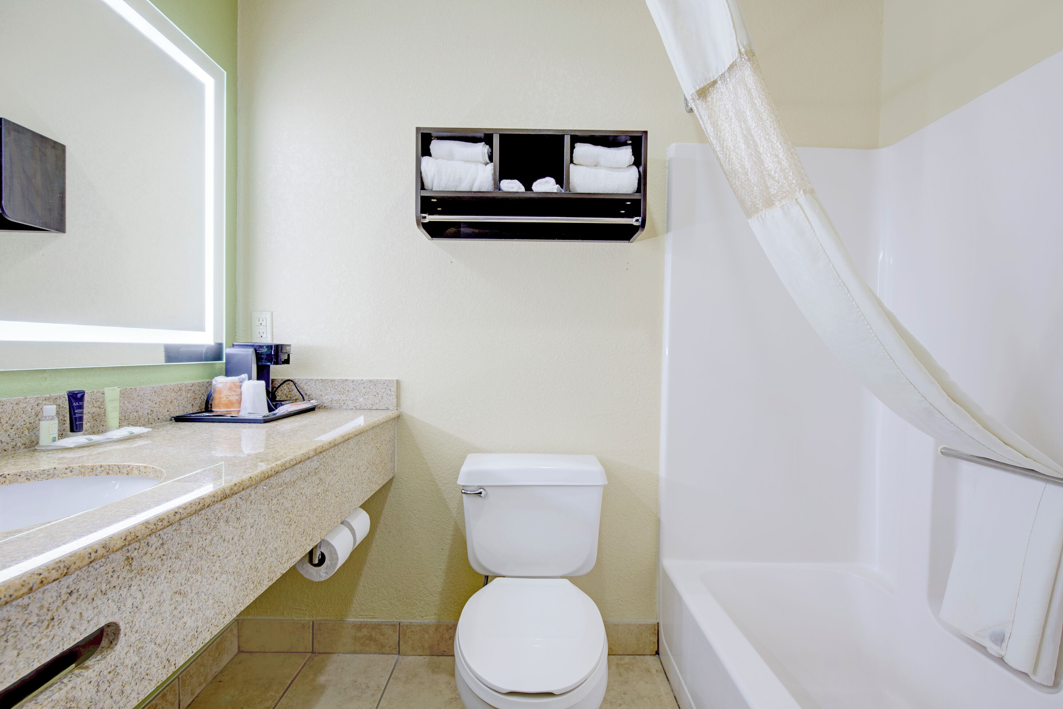 A bathroom with a toilet, sink, and shower.