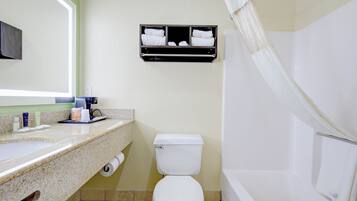 A bathroom with a toilet, sink, and shower.