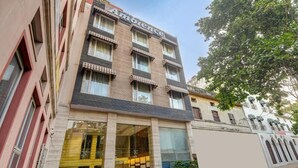 A multi-story building with a sign reading 'Ambience.' - Hotel Ambience (New Delhi)