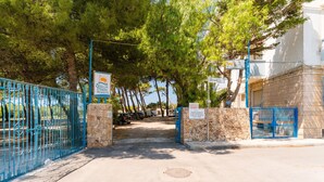 A gated entrance to a property with a sign indicating it is a residential area.