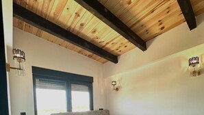 A bedroom with a bed, bedside tables, a window, and a wooden ceiling. - Vile Relax (Ulcinj)