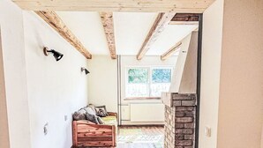 An interior with a wooden floor, a bed, a fireplace, and a window with a view. - Stunning private villa for 7 people with WIFI, TV and pets allowed (Chodov)