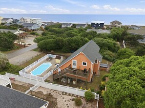 A residential property with a swimming pool, a fenced deck, and a view of the ocean. - Dog Friendly, Beach Home, Private Pool- 400ft to beach! (Emerald Isle)