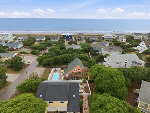 A residential area with houses, a swimming pool, and a beach in the background. - Dog Friendly, Beach Home, Private Pool- 400ft to beach! (Emerald Isle)