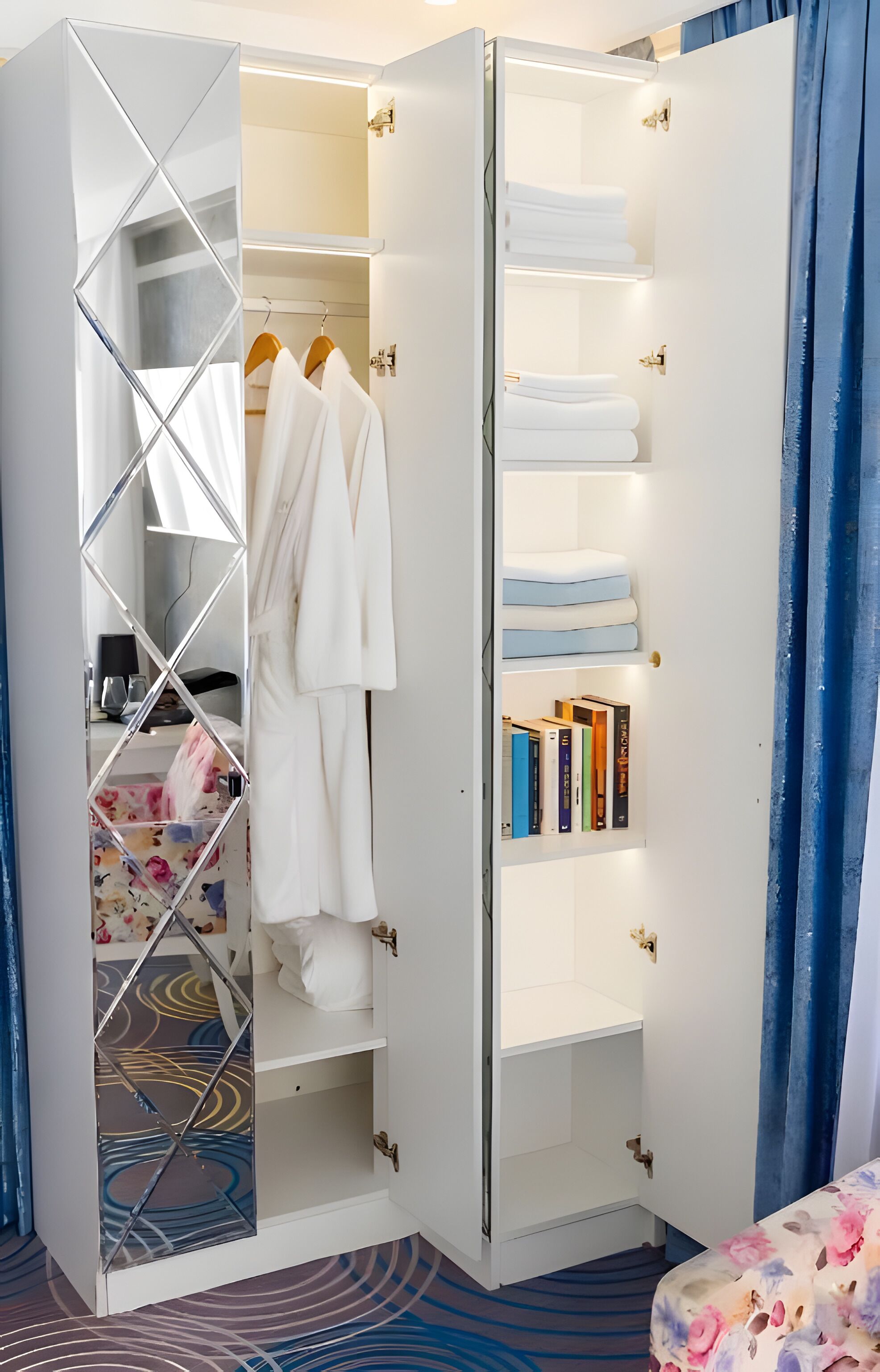 A walk-in closet with hanging robes, shelves with folded towels, and a mirrored section.
