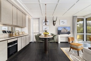 A modern kitchen with a dining area, a large window, and a mounted animal skull. - Dimora Elvezia Milano (Milan)