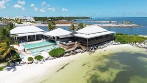 A resort with a pool, beach, and ocean view.