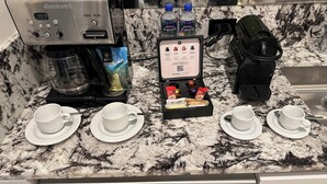 A kitchen with a Cuisinart espresso machine, a coffee pod holder, and a water dispenser. - Luxury King bed + bath Junior Suite + kitchenette. 2 guest plus all inclusive. (Cancún)