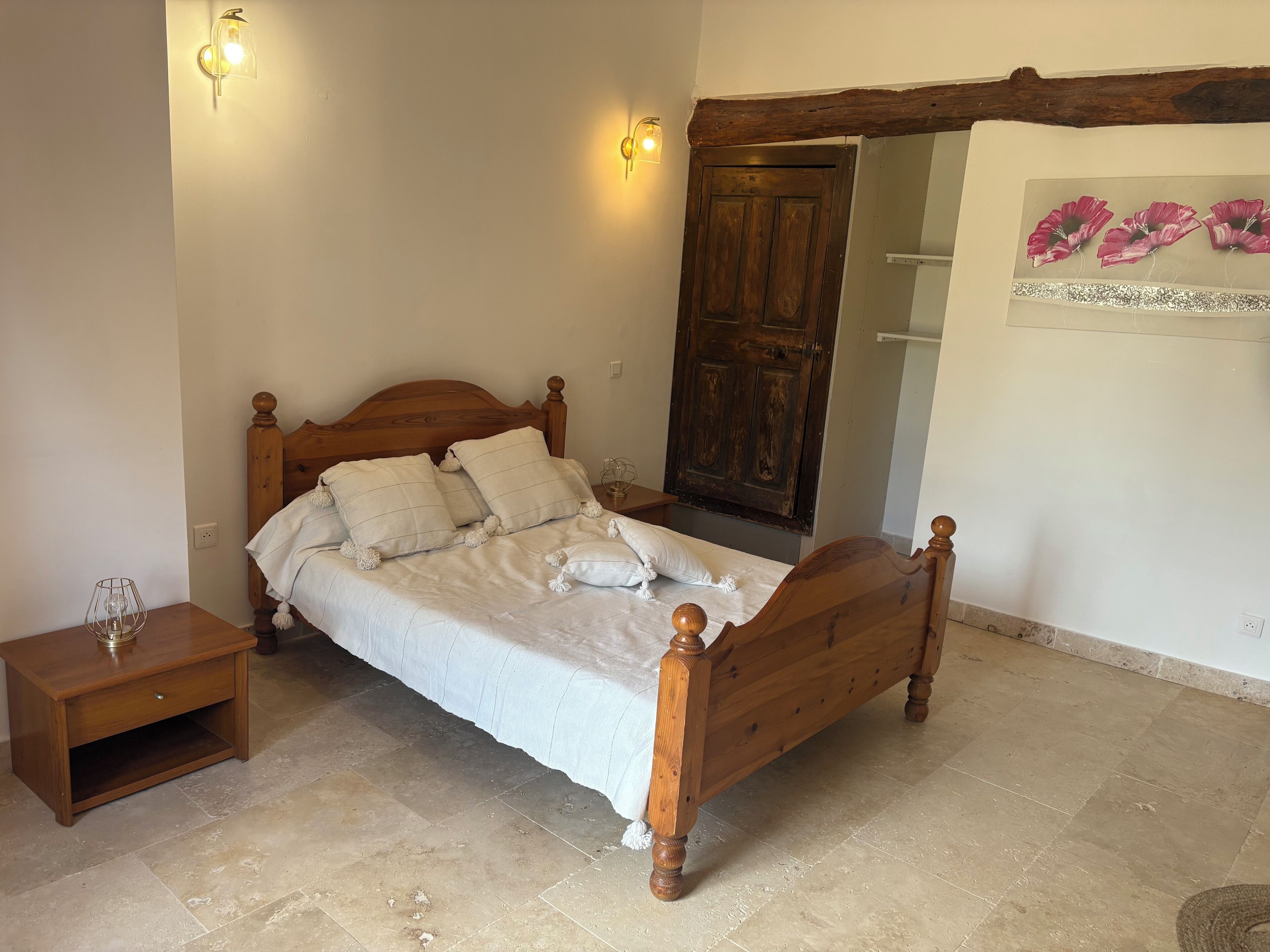 A wooden bed with a headboard, a bedside table, and a nightstand.
