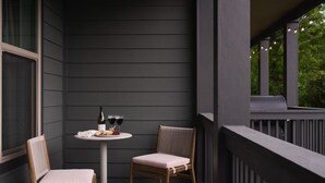 A balcony with a table, two chairs, a bottle of wine, and glasses. - New Luxe East Nashville Home • Sleeps 6 Near DWTN (Nashville)