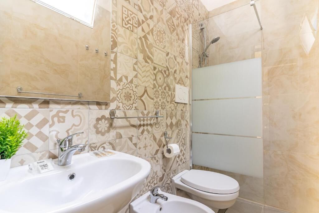 A bathroom with a sink, toilet, and shower.