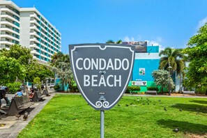 A sign for Condado Beach with a clear view of the beach and surrounding greenery. - Centric Paradise Villa with Pool, Whirlpool, Balcony (San Juan)