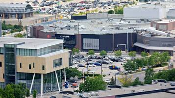 A commercial building with multiple floors, a parking lot, and a large sign for 'SQUAREONE'.