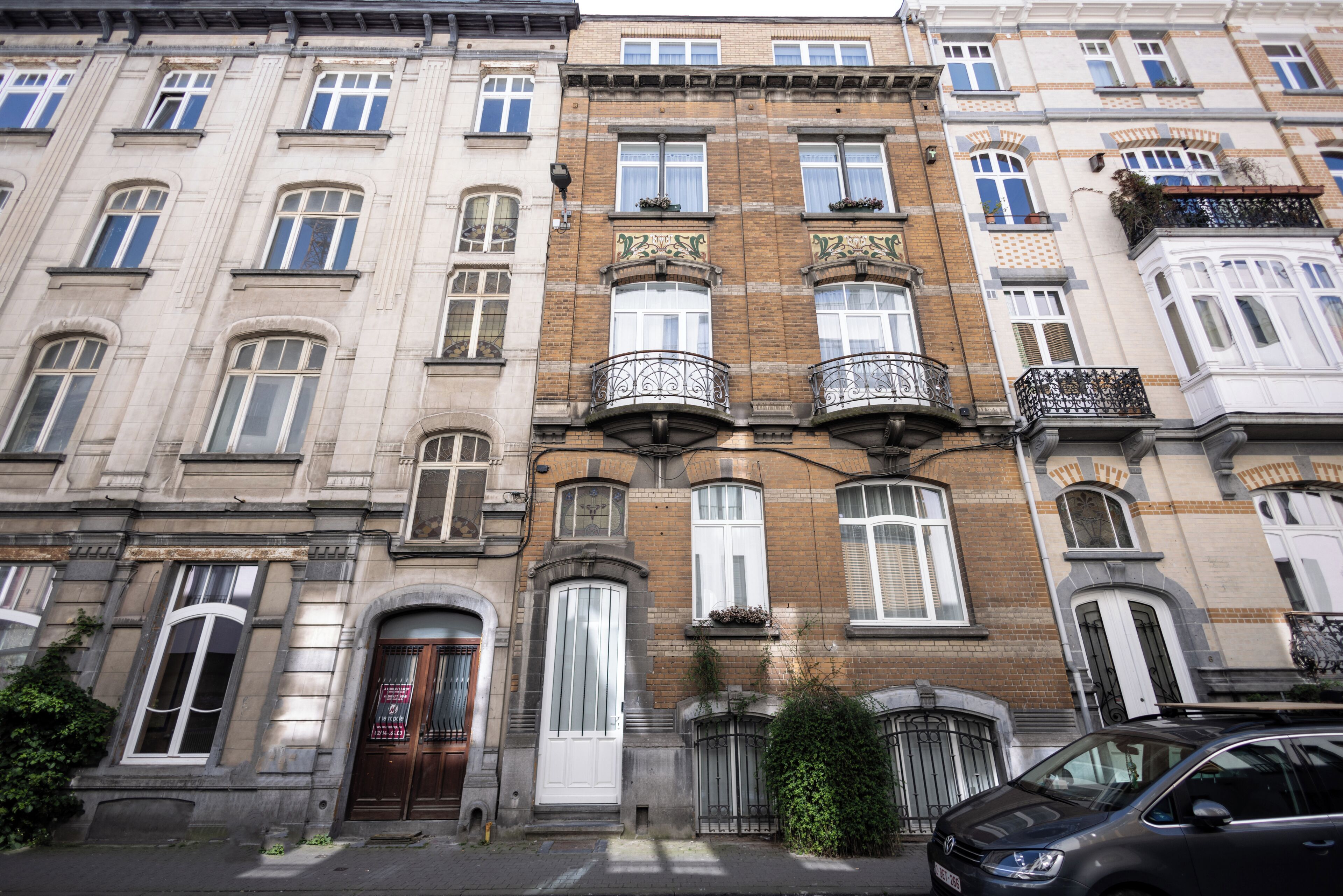 Una hilera de edificios de varios pisos con arquitectura tradicional, destacando balcones con barandillas de hierro forjado y amplias ventanas.
