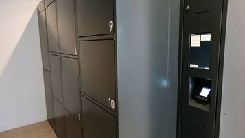 A row of numbered lockers, likely for storage or mail, in a modern interior with a light-colored floor.