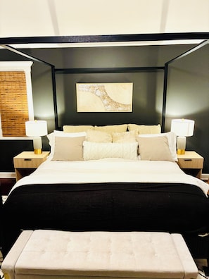 A bedroom with a bed, two bedside tables, a wall-mounted artwork, and a bench. - Cozy Fully Furnished 5B4B Palos Heights Oasis (Palos Heights)