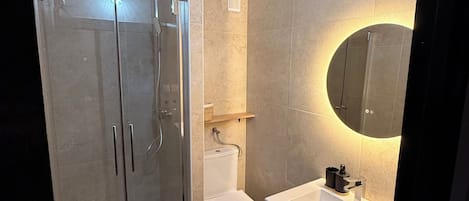 Shower, hair dryer, towels, toilet paper
