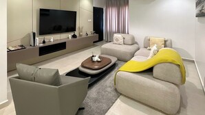 A modern living room with a flat-screen TV, sofa, and coffee table. - Dorville Hotel And Suites (Orerokpe)
