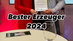 Two people holding a framed certificate with 'Bester Erzeuger 2024' text.