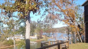 A lakeside view with a wooden dock and boats.