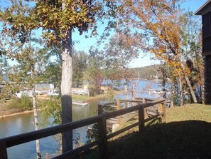 A lakeside view with a wooden dock and boats.