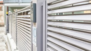 A metal gate with a security keypad and a sign indicating a 'Coco Cavour' property. -  Casa Cavour - In Val di Susa con Parcheggio Moto (Bruzolo)