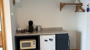 A compact kitchen with a microwave, coffee maker, and a small refrigerator. - Juniper Motel*King*RM15*Dock*ATV Access*Waterfront*Kayak/Boat Rentals (Greenville)