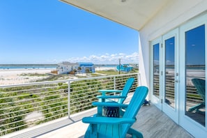 A balcony with chairs overlooking a beach and ocean. - Endless Views (St. Augustine)