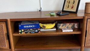 A wooden desk with a shelf containing books and a framed picture. - Luxury Stay w/ Fenced Yard, Hot Tub, Mountain View (Afton)