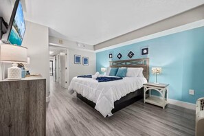 A hotel room with a bed, a TV, a desk, and a chair. - Oceanview - Watch Dolphins from balcony - Parking (Myrtle Beach)