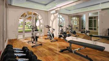 A gym with exercise equipment, a bench, and a large mirror reflecting the space.