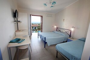 A bedroom with a bed, bedside table, desk, chair, and a television. - Hotel Residence Il Gattopardo (Ricadi)