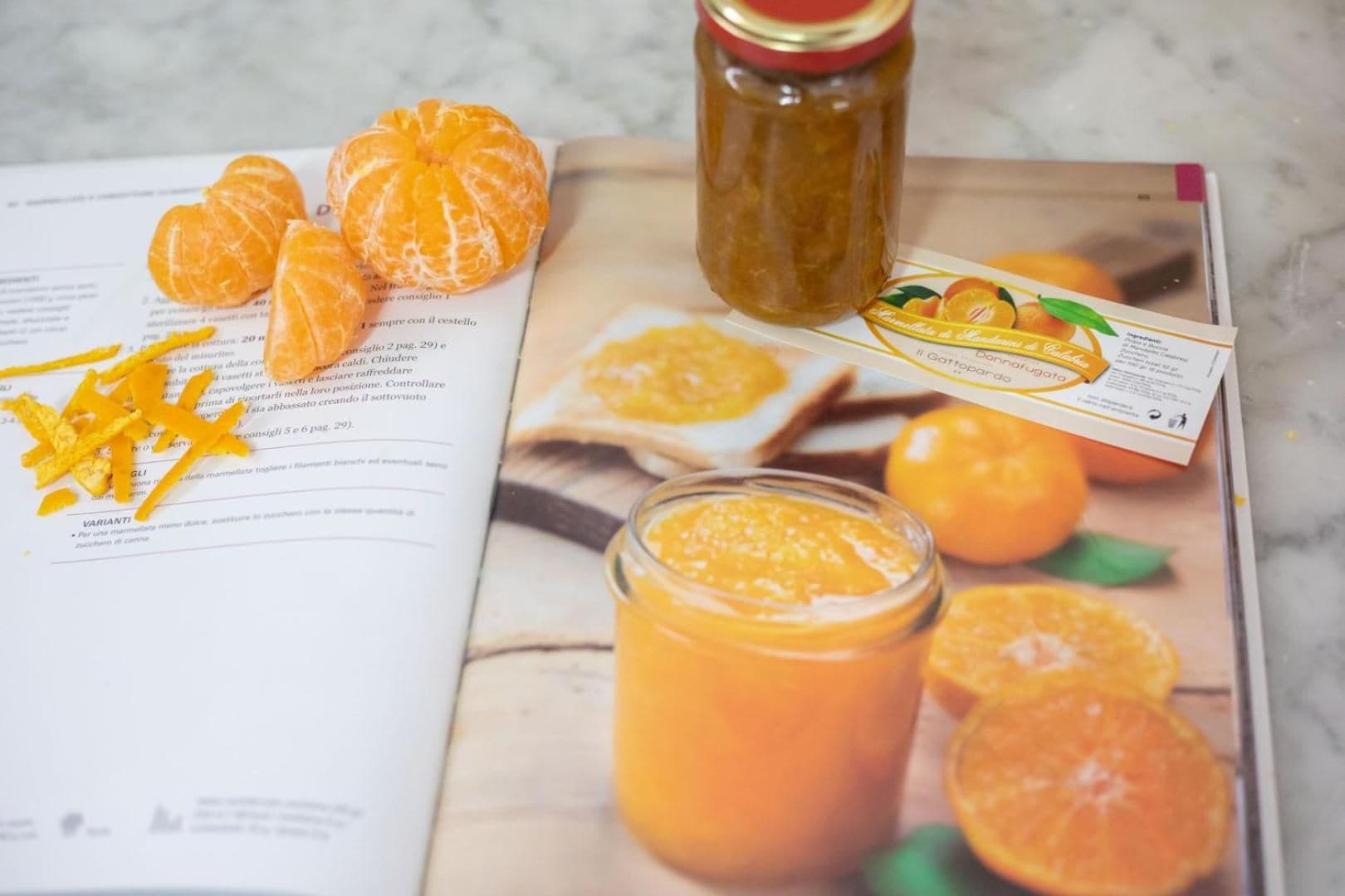 A magazine with a recipe featuring oranges, a jar of orange marmalade, and a glass of orange juice.