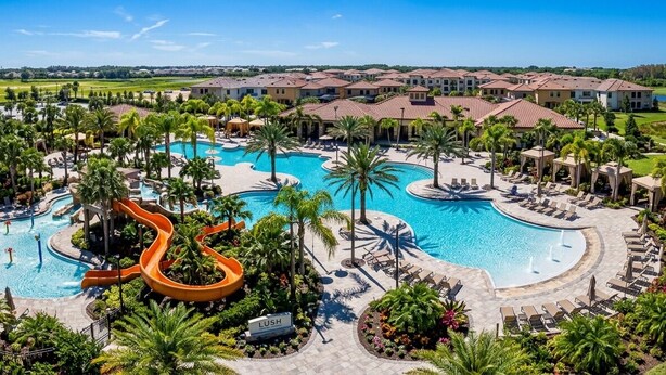 A resort with multiple swimming pools, palm trees, and a golf course in the background. - King Ensuite Private Bath Shared Home (Davenport)