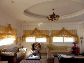 A living room with a sofa, armchair, ottoman, and a coffee table.