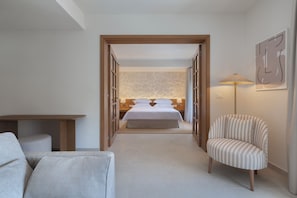 A bedroom with a bed, a chair, a desk, and a lamp. - Heritage Hotel Kastelet (Tucepi)