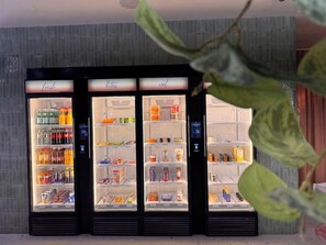 Three beverage vending machines with various drink options. - Aparthotel Goldey (Unterseen)