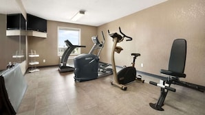 A fitness room with a treadmill, elliptical, and stationary bike. - Days Inn Calgary Airport (Calgary)